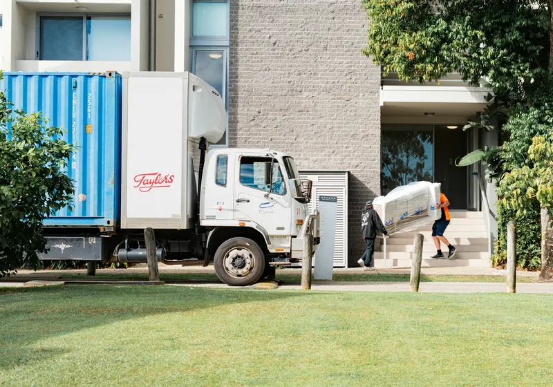 Movers carrying boxes to a truck